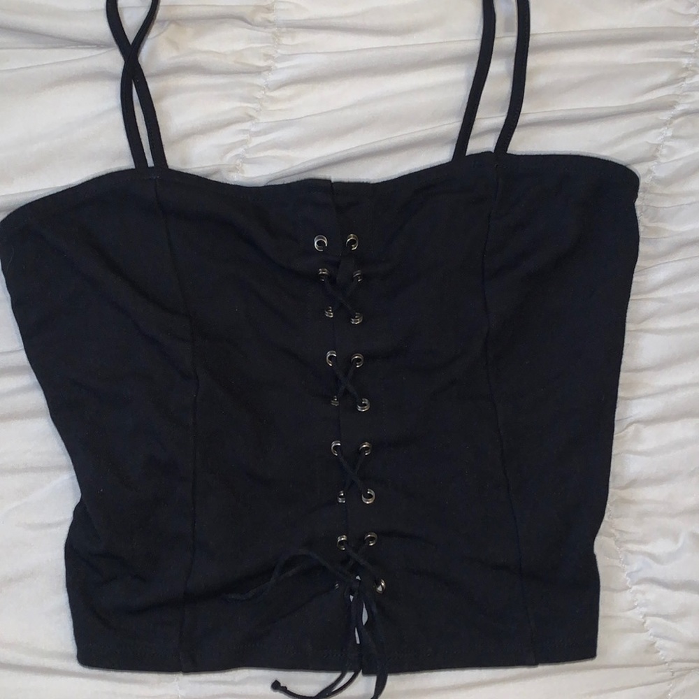 Black shirt with lazes across.